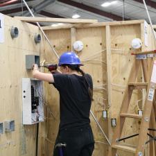 Female student competing in Skills Canada competition for electrical wiring